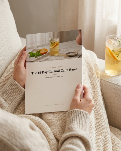 The 14-Day Cortisol Calm Reset held in hand — lifestyle